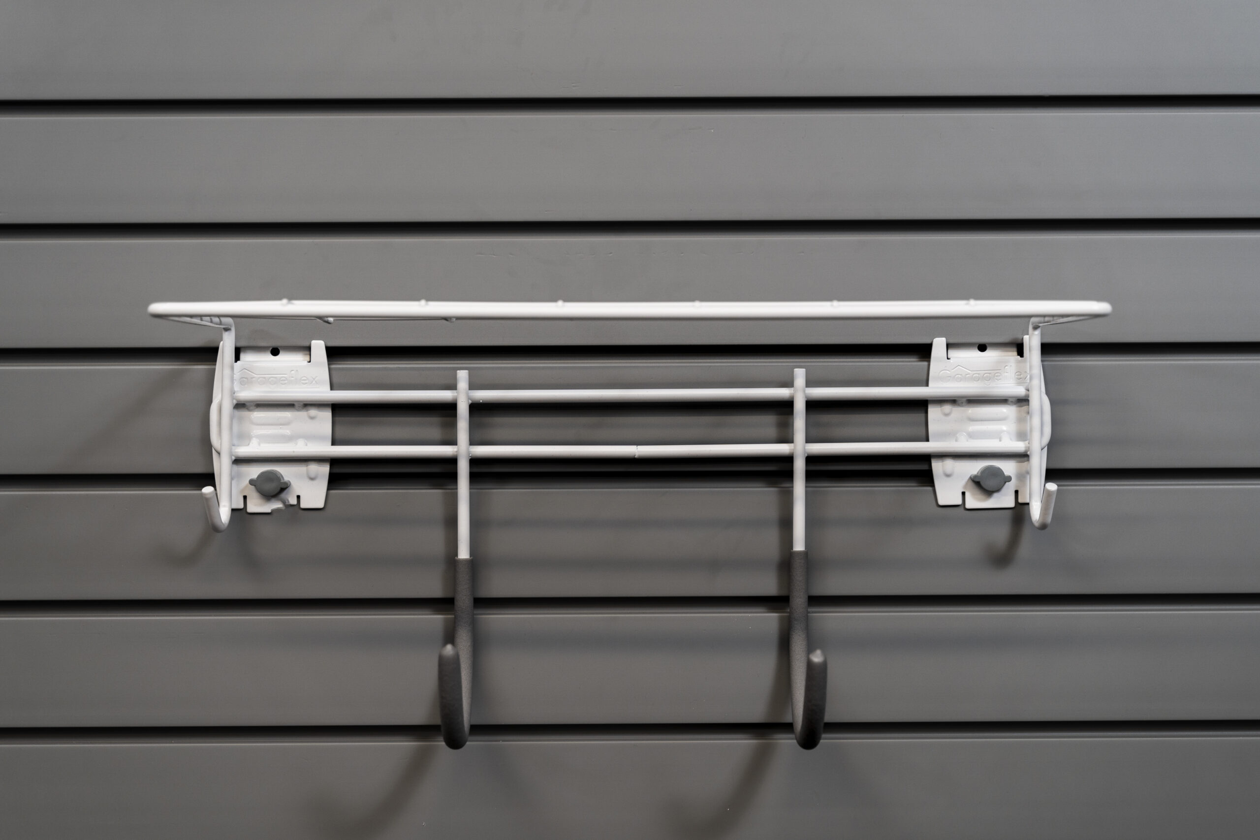 shelf with 2 hooks attached to slatwall