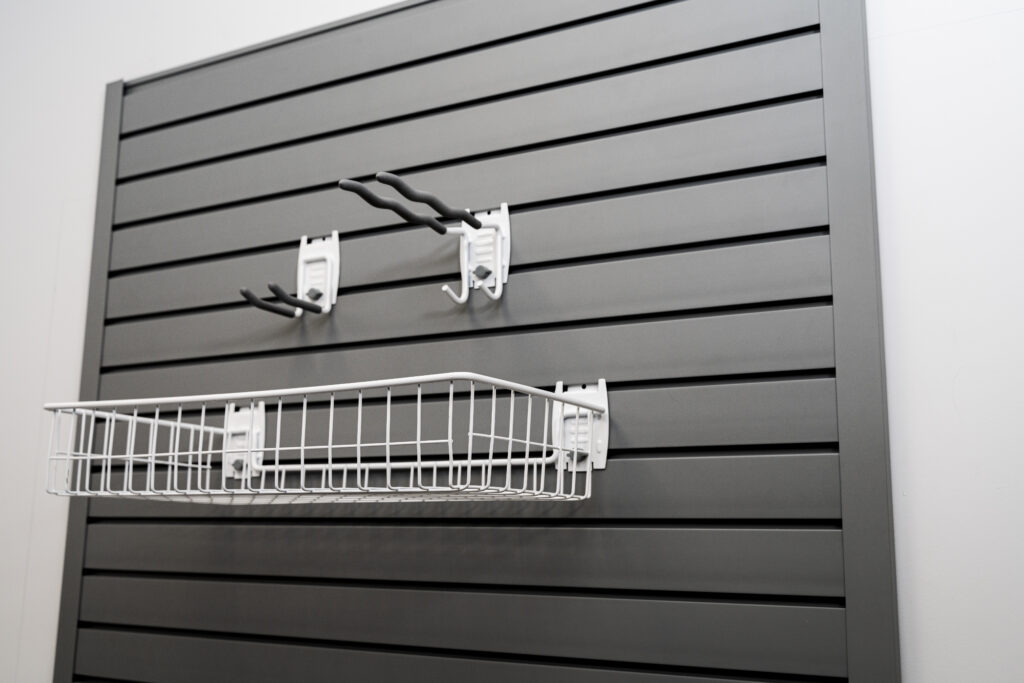 grey flexipanel slatwall panel with hooks and basket attached